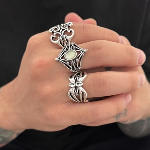 Three-piece set of vintage silver punk rings featuring hollow patterns and opal stone