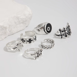 Detail of 6-piece punk pentagram ring set in vintage silver finish on white stones