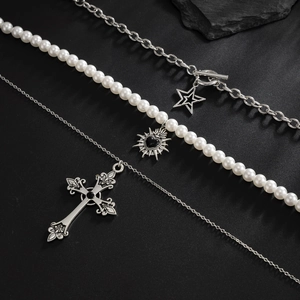 Close-up of pearl heart, star, and cross pendants on metal hip-hop necklaces set