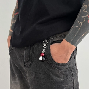 Street style keychain with silver star clasp, red bead, and black billiard ball 8 pendant