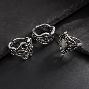 Detail view of retro hip-hop rings with geometric patterns and opal stone inlay