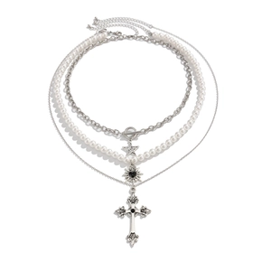 Layered gothic necklace featuring pearl beads, star pendant, heart charm, and silver cross