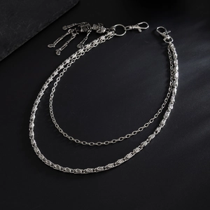 Detail of silver double-layered punk pants chain featuring a full skeleton skull pendant