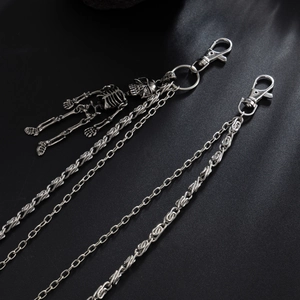 Gothic silver punk wallet chain set with skeleton charm on dark silk background