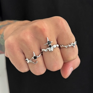 Set of three silver gothic star rings featuring black gemstones and sharp spikes