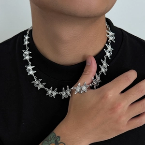 Men street style star chain necklace in polished silver finish worn by a model
