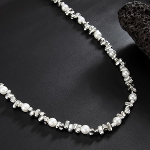 Macro detail of men's pearl and irregular silver metal link hip-hop style trousers chain