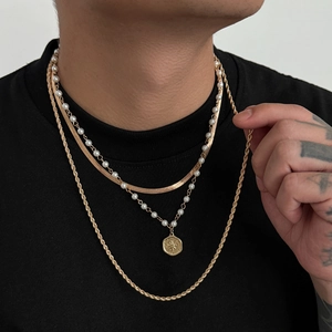 Three-layer gold necklace set with flat snake chain, pearl pendant, and twist rope chain
