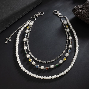 Detailed view of triple-layered hip hop trousers chain with pearls and cross pendant