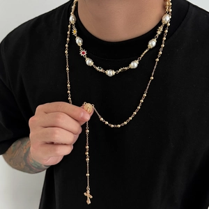Men's double-layer gold beaded and pearl necklace set with cross pendant on black tee