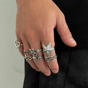 Set of five vintage silver gothic star rings for men shown on hand in punk style