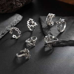 Detail of seven-piece vintage star rings set with retro blackened finish on black stone