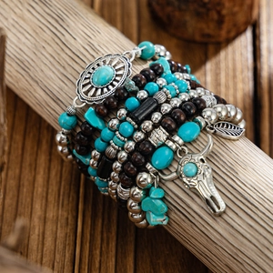 Detail of bohemian layered bracelets with turquoise beads and silver bull head charm