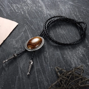 Western Bolo Tie featuring a brown tiger eye stone with silver engraved floral metal border