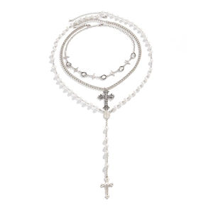 Gothic multilayer silver necklace set with cross pendant and pearls on white background
