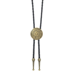 Detail of vintage bronze floral engraved bolo tie buckle and black braided leather cord