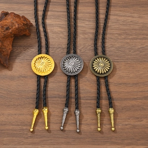 Vintage western bolo ties with sunburst metal buckles on rustic wood background