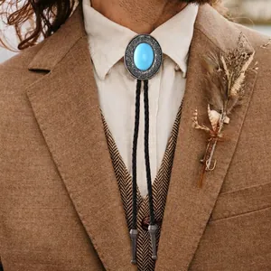 Vintage western bolo tie with blue turquoise pendant on black woven leather cord