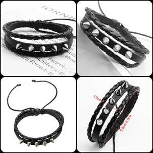 Detail of black punk leather bracelet with silver metal spikes and adjustable cord