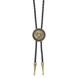 Detail of vintage gold bolo tie slide with floral engraving and black braided cord