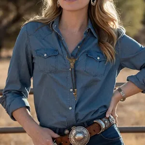 Western bolo tie with bull skull pendant and woven leather cord worn on denim shirt