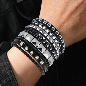 Macro detail of punk multi-layer bracelet set with silver studs and black beads