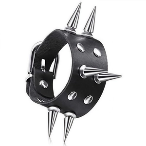 Detail view of double-row silver cone spikes and studs on a black leather punk bracelet