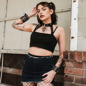 Detail of black punk leather wristband with silver metal spikes and street rock style