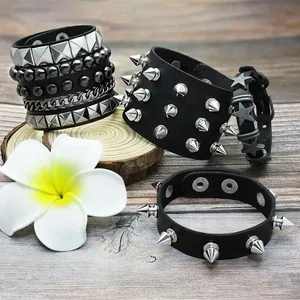 Set of 6 punk black leather bracelets featuring metal spikes and star charms on wood