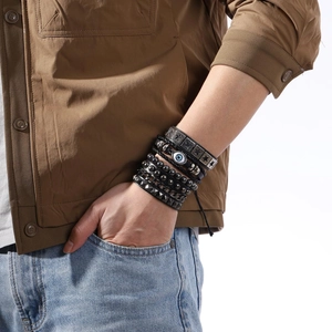 Men's multi-layer leather bracelet set with evil eye and star charms on wrist
