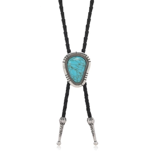 Detail of vintage bolo tie showing turquoise pendant and carved silver alloy tips