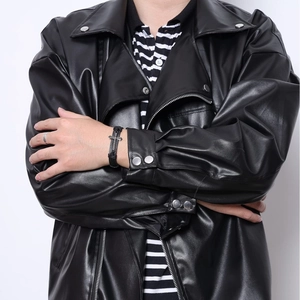 Men's vintage cross woven leather bracelet and casual black jacket streetwear look