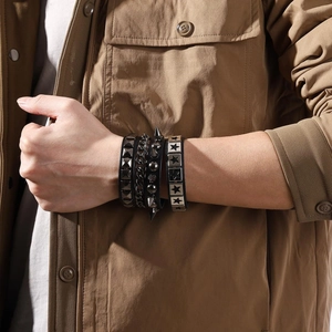 Detailed view of punk black leather wristbands with metal studs and star accents