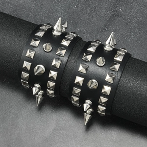 Set of two black punk leather wristbands with gothic metal pyramid studs and sharp spikes