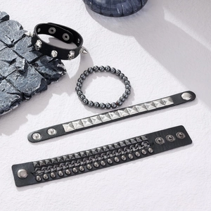 4-piece men's punk bracelet set with studs, chains and skulls on white background