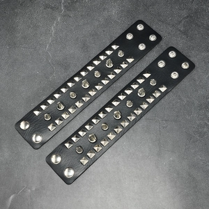 Pair of punk black PU leather bracelets with silver pyramid and cone metal studs