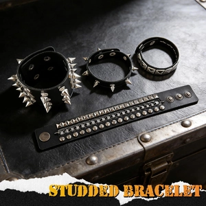 Set of 4 punk black leather bracelets with metallic studs and spikes on a vintage case