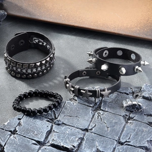 Set of four black punk leather bracelets featuring metal rivets, studs, and star charms