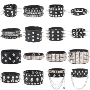 Set of 16 punk rock black leather bracelets with silver metal spikes and studs on white background