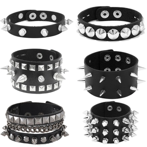 Close-up detail of punk leather bracelets with silver spikes and pyramid metal studs