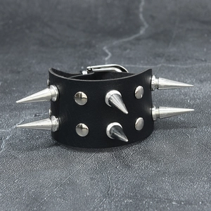 Close-up of black leather punk bracelet featuring silver metal spikes and belt buckle