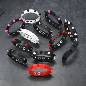 Set of punk style leather bracelets with conical metal spikes and adjustable snap buttons