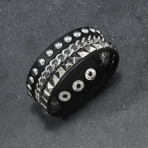 Detail of punk leather bracelet with rivets, silver chains, and adjustable snaps
