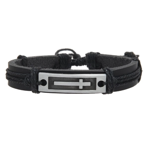 Detail of men's braided leather bracelet with a vintage silver metal cross charm