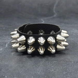 Close-up of double-row silver metallic spikes on black leather punk rock bracelet