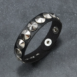 Punk style black leather bracelet featuring silver cone studs and snap buttons