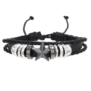 Detail view of multilayer punk leather bracelet with vintage metal star and braided cords
