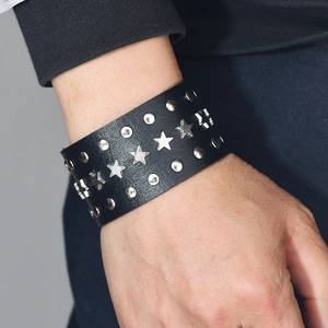 Punk rock wide black leather bracelet with star studs and snap closure on wrist