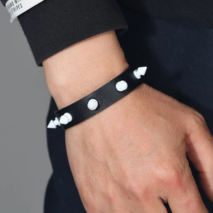 Punk leather bracelet featuring white cone studs on black wristband for men and women