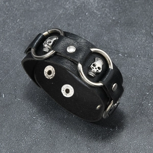 Punk black leather bracelet with silver skull metal rings and adjustable snap closure